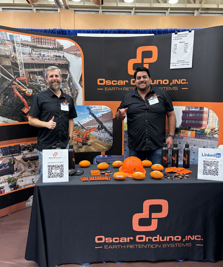 Oscar Orduno Inc. team members at a Dallas construction career fair showcasing earth retention and shotcrete project displays.
