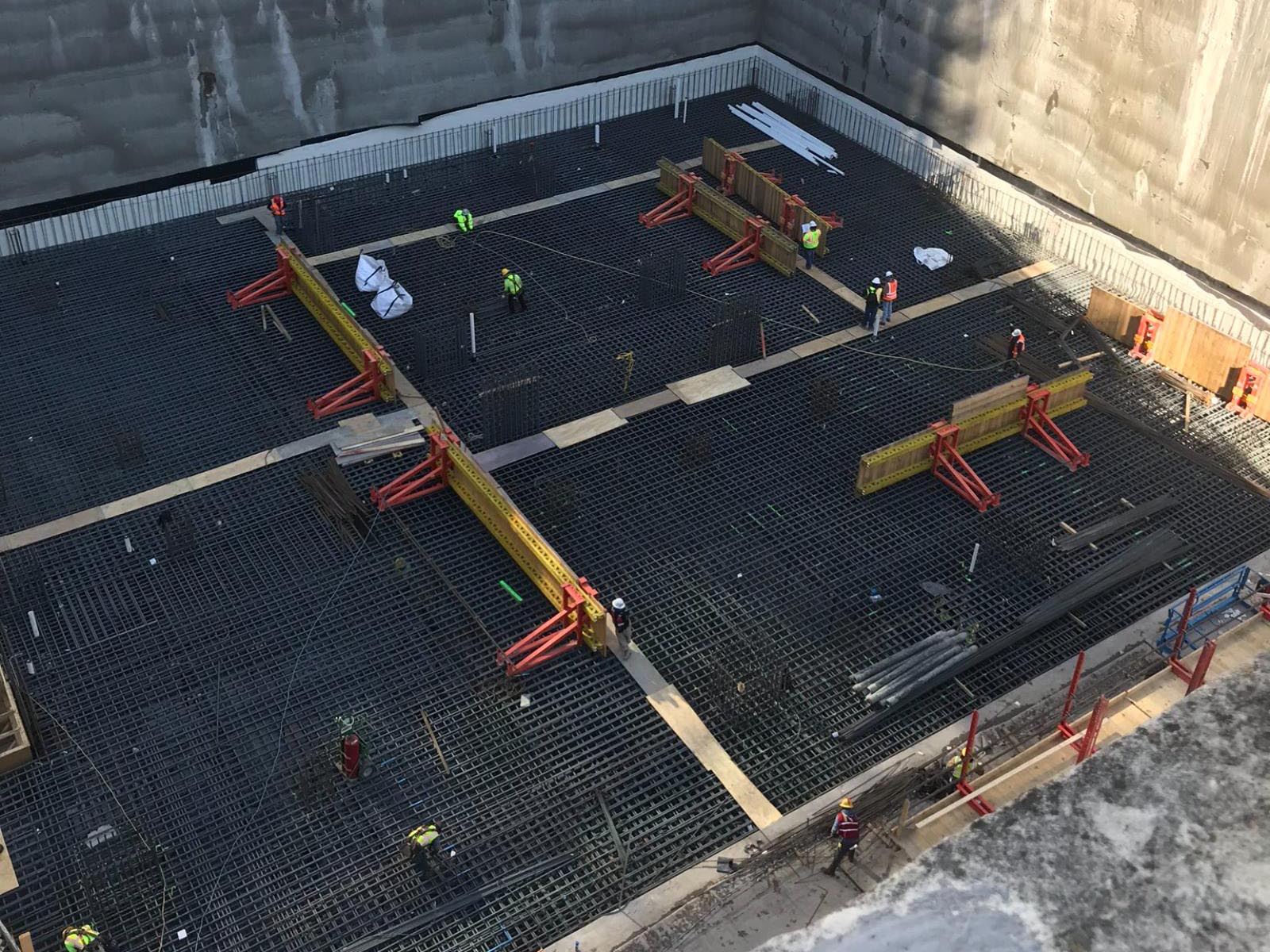 Oscar Orduno, Inc. field crew installing structural steel reinforcement for a large-scale urban foundation project at Indeed Tower in Austin, Texas.