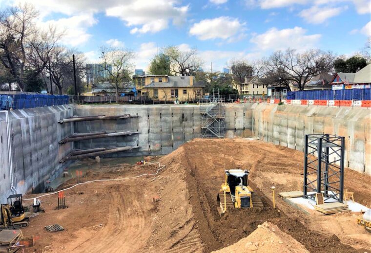 Deep excavation on Cesar Chavez in Austin, Texas, featuring Anchor Soldier Pile System, Tieback Anchors, and Corner Bracing by Oscar Orduno, Inc.