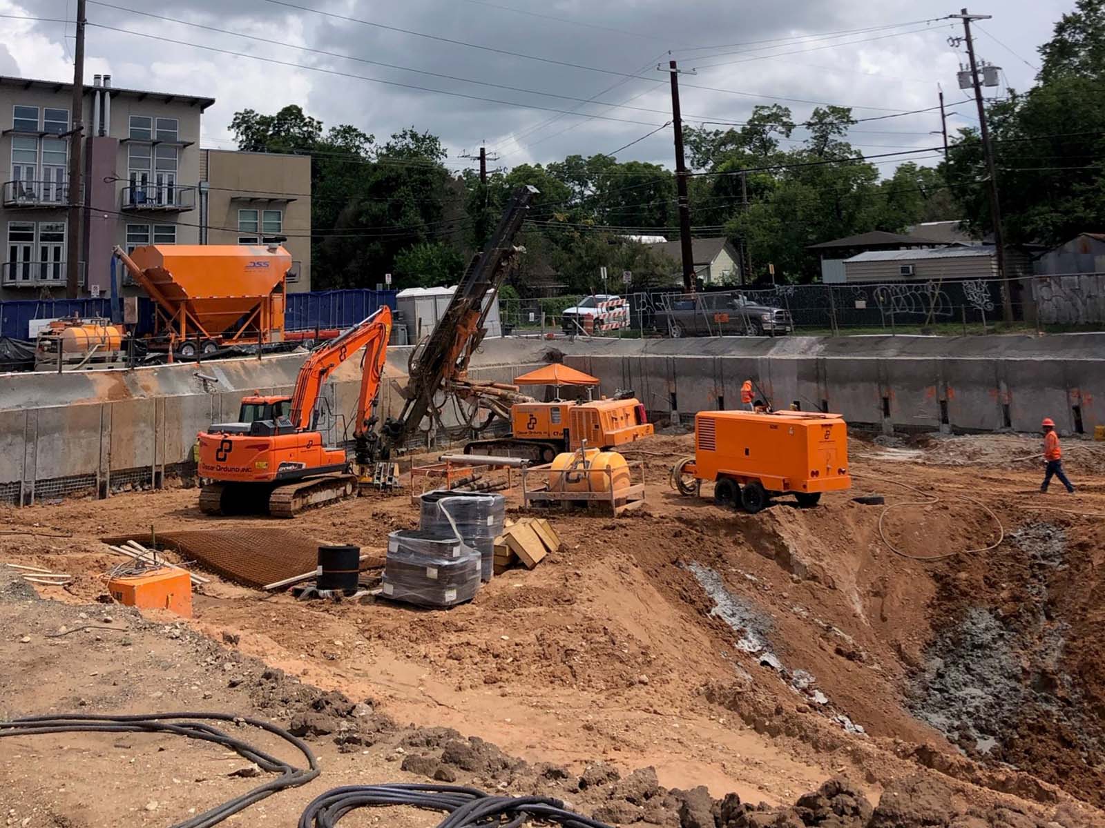 Deep excavation near Cesar Chavez in Austin, Texas, featuring Anchor Soldier Pile System and specialized Tieback Anchor drilling by Oscar Orduno, Inc.