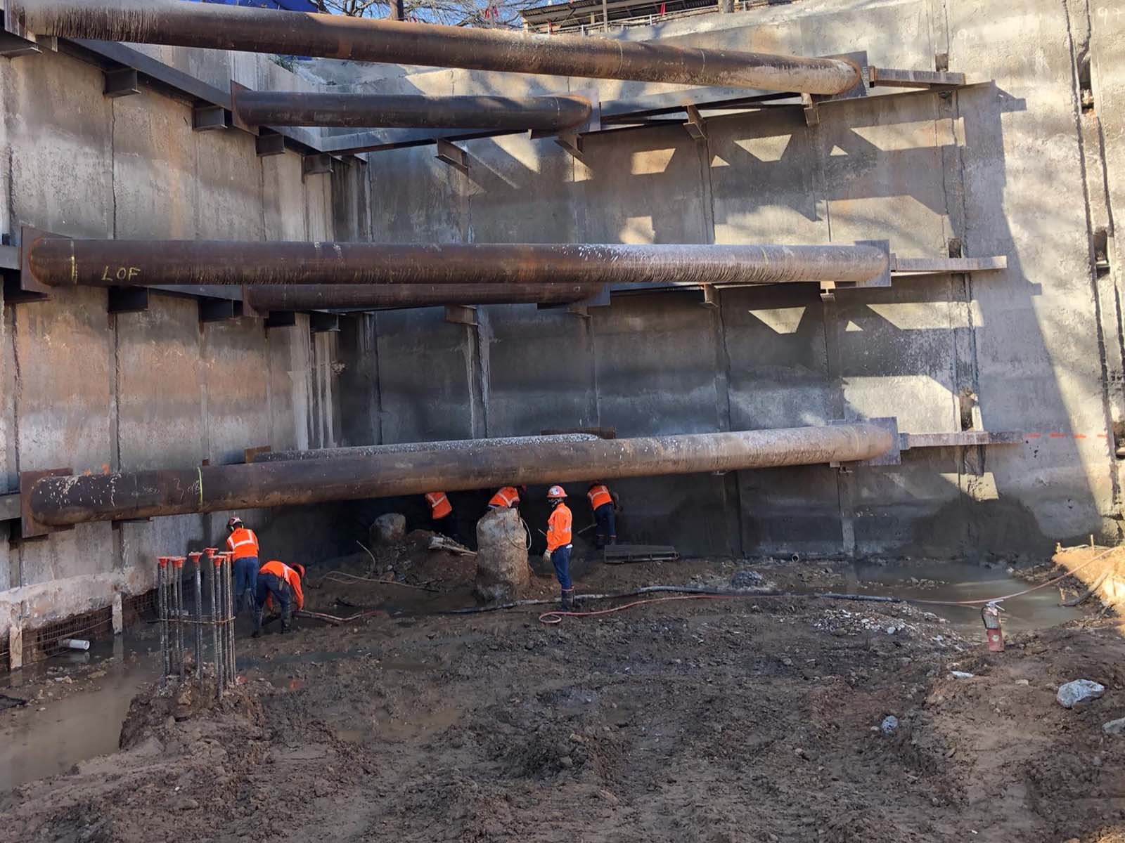 Field crew performing structural reinforcement for an Anchor Soldier Pile System with heavy Corner Bracing in Austin, Texas.