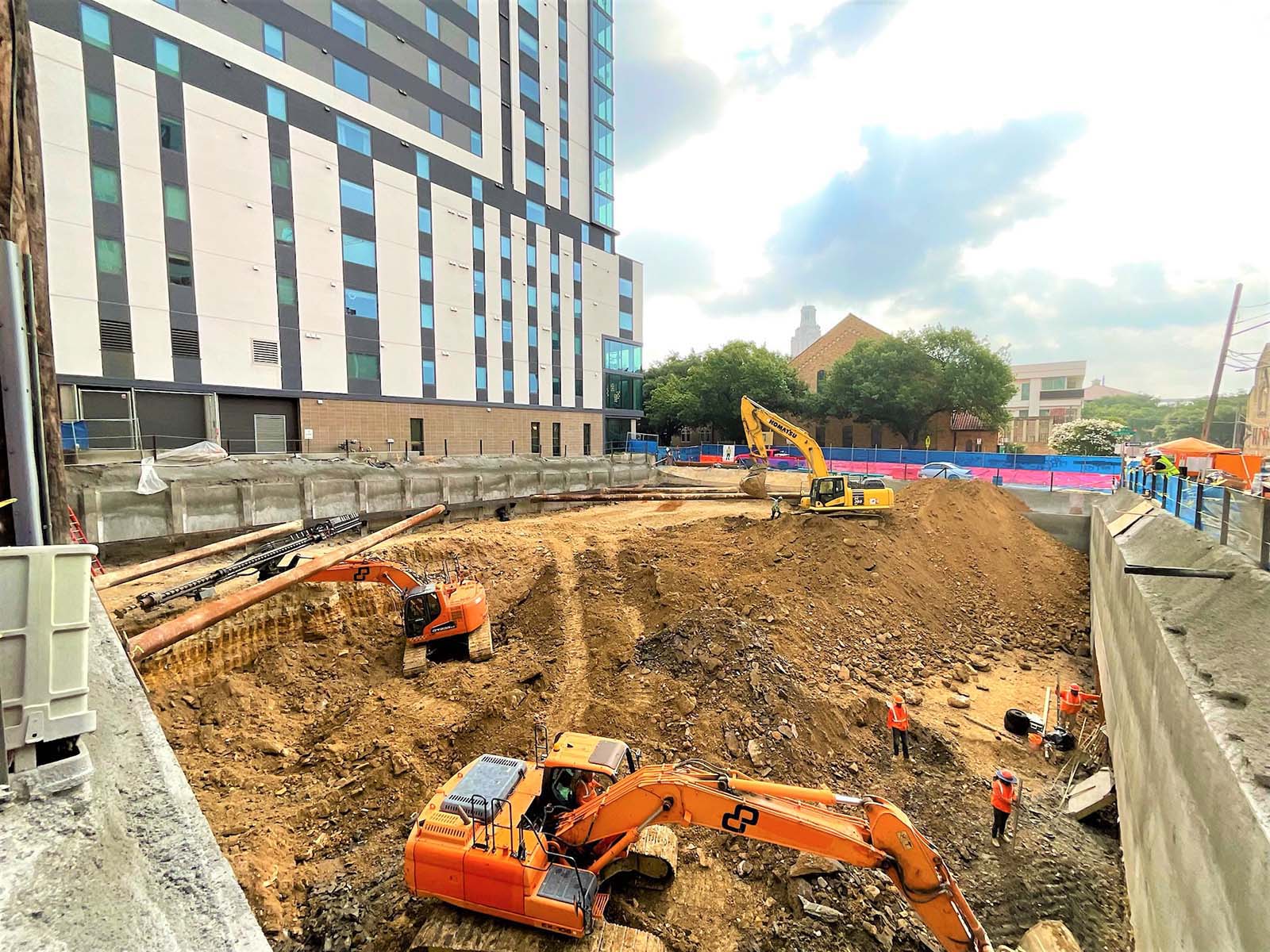Advanced internal bracing system with steel struts and shotcrete-finished soldier pile walls by Oscar Orduno, Inc. for deep urban shoring.