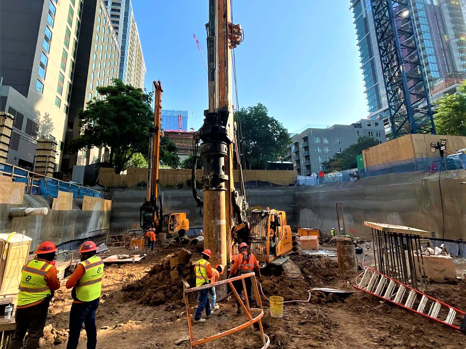 Field crew and specialized drilling rigs from Oscar Orduno, Inc. installing Anchored Soldier Piles and Tieback Anchors at Paseo 80 Rainey in Austin, TX.