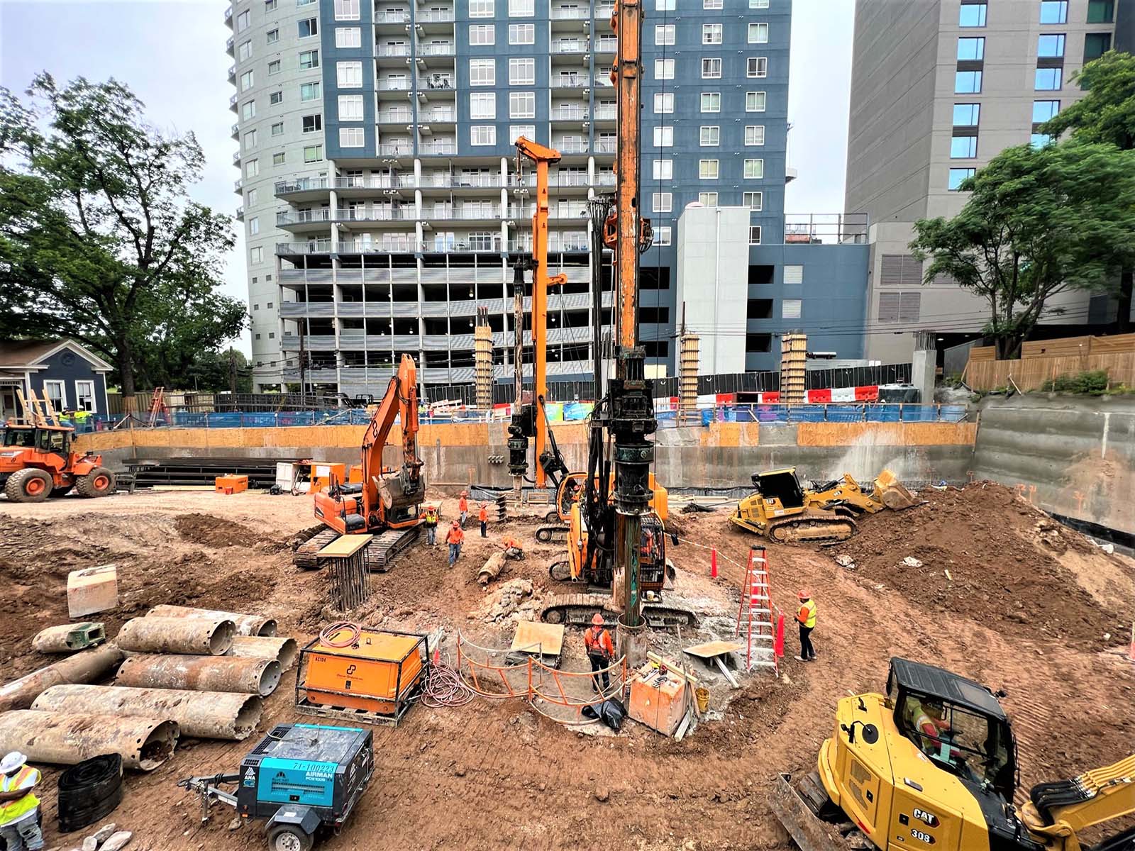 Extensive drilling and earth retention fleet from Oscar Orduno, Inc. installing Anchored Soldier Piles and Soil Nail Anchors at Paseo 80 Rainey in Austin, TX.