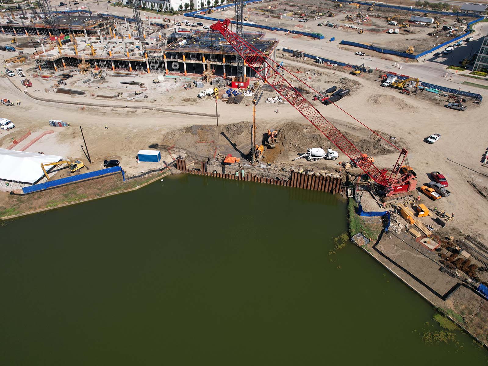 High-capacity Oscar Orduno, Inc. drilling rig and crawler excavator performing precision foundation boring for a waterfront development.