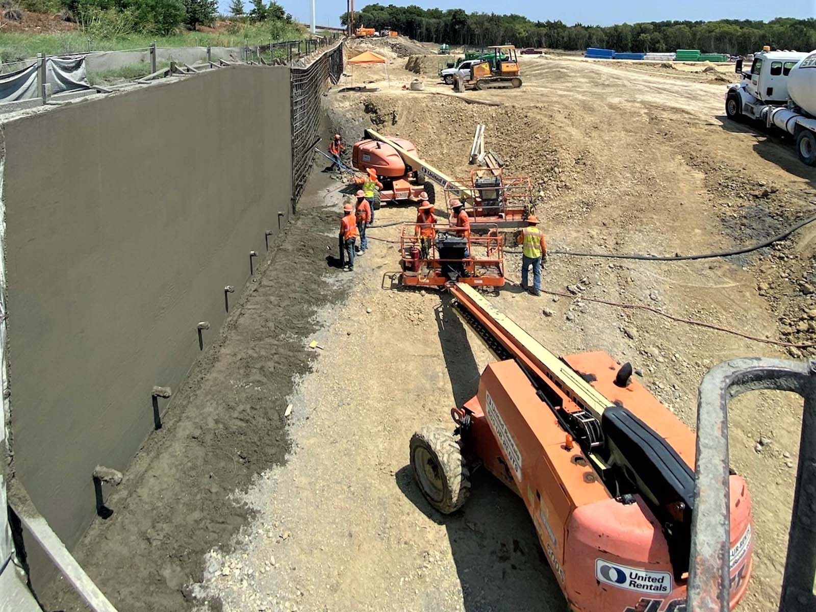 Oscar Orduno, Inc. field crews applying specialized finishes to a permanent drilled shaft wall for highway stabilization in Austin, Texas.