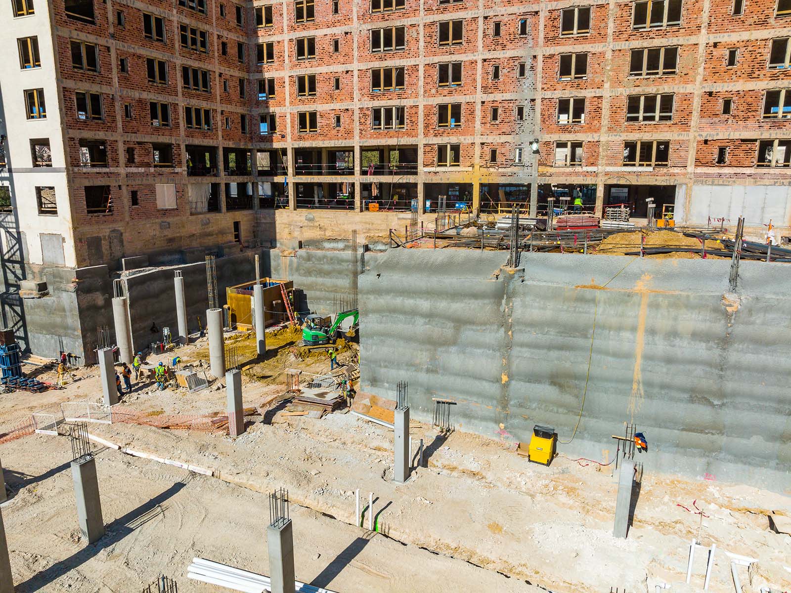 Ground-level view of a high-capacity shotcrete wall and reinforced foundation columns engineered by Oscar Orduno, Inc.
