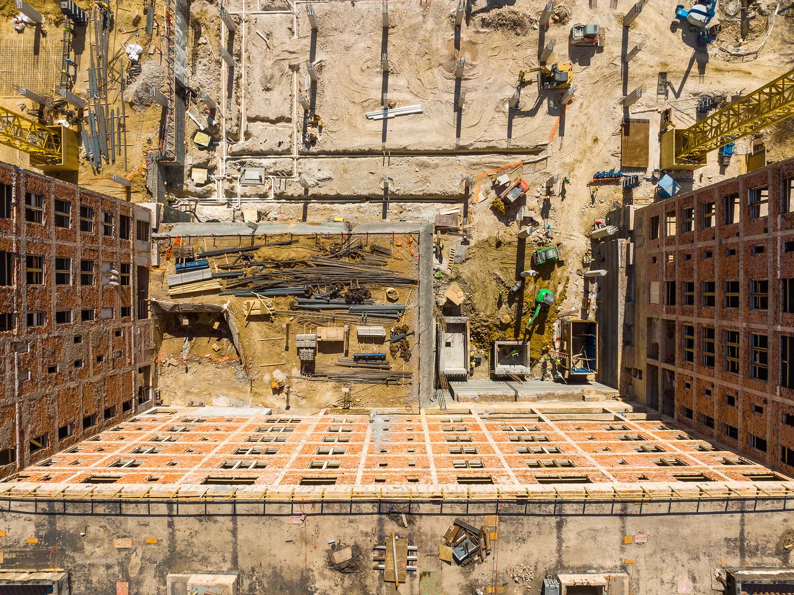 Aerial view of a major metropolitan construction site featuring deep foundation columns and earth retention systems managed by Oscar Orduno, Inc..