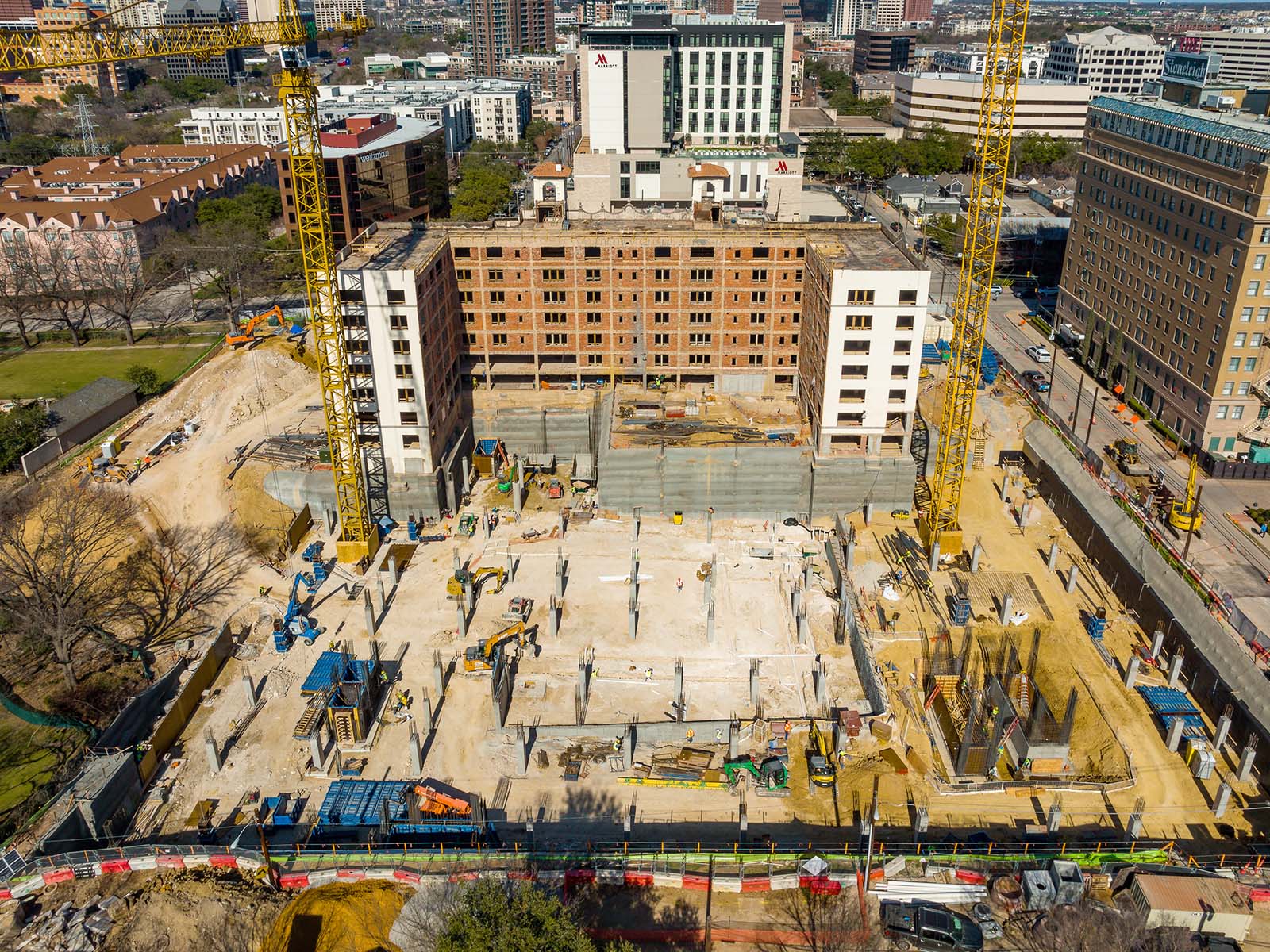 Aerial view of a major metropolitan construction site featuring deep foundation columns and earth retention systems managed by Oscar Orduno, Inc..