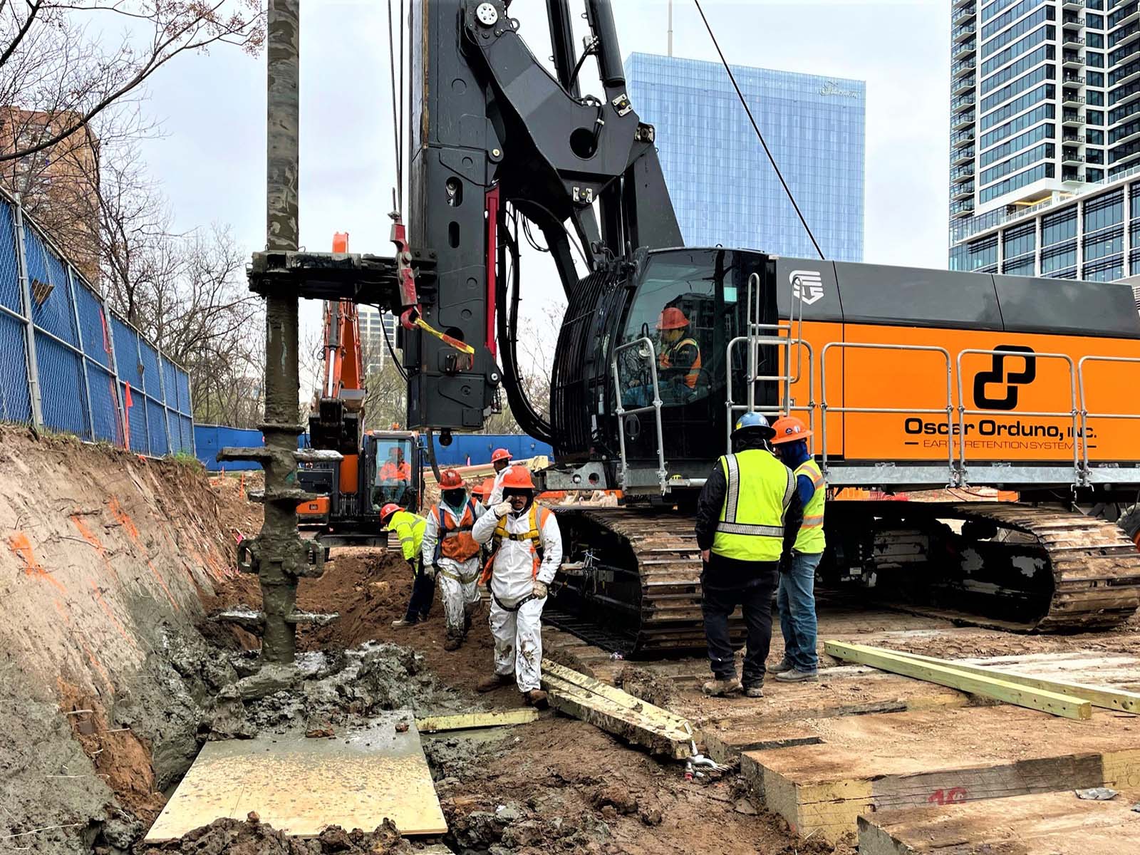 Close-up of Oscar Orduno, Inc. crews using a specialized soil mixing rig to install a cut-off wall at The Travis in Austin, Texas.