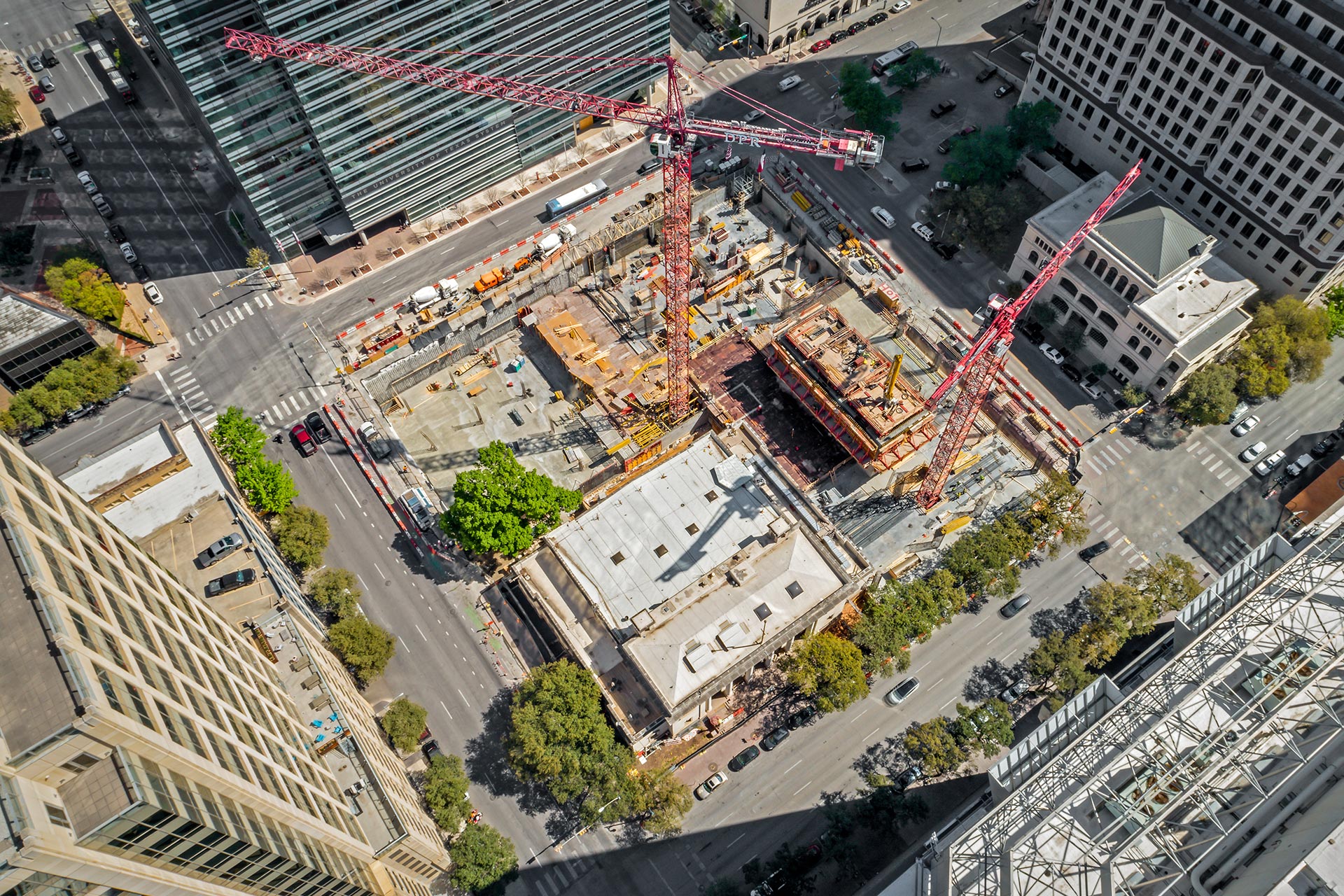 Aerial view of a major urban high-rise construction site featuring Oscar Orduno, Inc. earth retention systems and mass excavation services.